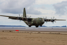 A Royal Air Force Lockheed C-130J 'Super Hercules' Performing Tactical Landings And Takeoffs From The Public Beach At Cefn Sidan Sands In West Wales.