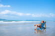 © CandyRetriever  - Asian man resting on beach chair at tropical beach. Happy guy sunbathing or nap on sunbed by the sea in sunny day. Young man relax and enjoy beach outdoor activity lifestyle on summer holiday vacation