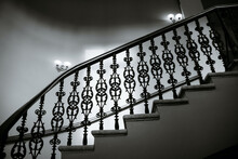 View Of A Staircase With Patterned Cast Iron Railings, In Black And White