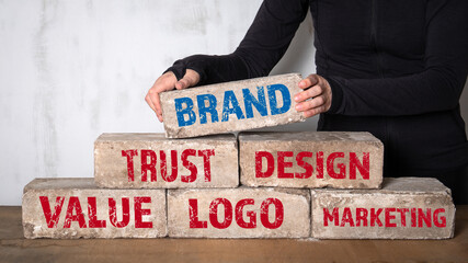 Wall Mural - brand. marketing, value, design and logo concept. stack of white bricks on a wooden table