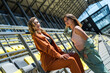 © RomanR - two slim sporty young women relax after exercise sitting on the seats at the stadium