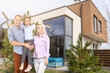 © Angelov - Happy family. family on the background of a new house. Modern new house is on the background.