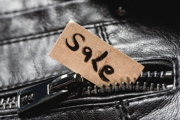 Sale tag label in the clothes pocket close up background. Discount concept.