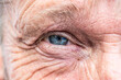 © CL-Medien - Close-up macro view on the blue eye of senior man smiling