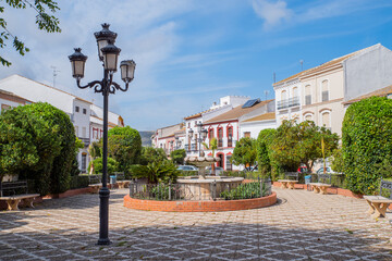 central square with a fountain and a church in a town of Almargen in Malaga Andalusia