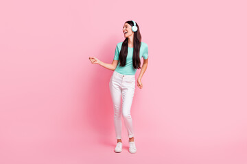 Poster - Full size photo of young attractive lovely happy positive girl in headphones dancing isolated on pink color background