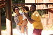 © liderina - African American family with one child having fun outdoors.