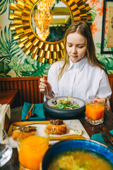 Wall Mural - young beautiful woman have dinner in cafe