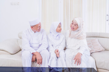 Wall Mural - Muslim child chat with her grandparents at home