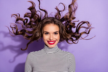 Wall Mural - Photo of young attractive woman happy positive smile fly air curly hair isolated over violet color background