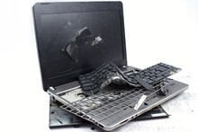 The Laptop Is Smashed To Pieces. The Screen Is Cracked, The Keyboard Is Broken. Electro Waste.