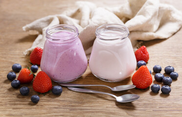 Wall Mural - glass jars of yogurt with fresh berries