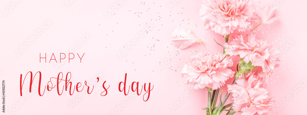 Banner with pink carnations on pink background with Happy Mother's day greeting. - obrazy, fototapety, plakaty 