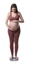 Canvas Print - Pregnant woman standing on scales against white background