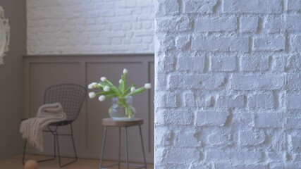Wall Mural - Vase of plant flower background with white brick wall close up, black chair mirror and blanket style.