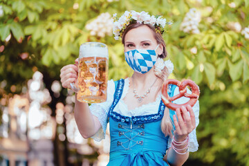 Wall Mural - Bavarian woman toasting with beer during covid 19