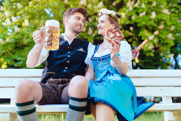 Wall Mural - Woman and man in Bavarian tracht enjoying the country