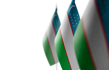 Poster - Small national flags of the Uzbekistan on a white background