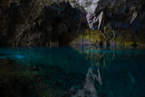 Fototapeta Dziecięca - Light descends into the darkness of a submerged cavern with blue lake. Concept of travel and adventure.