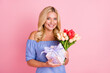 © deagreez - Photo of optimistic blond curly hairdo lady hold present flowers wear top isolated on pastel pink color background
