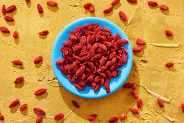 Poster - dried goji berries in a blue plate