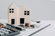 © Deemerwha studio - House model with the real estate agent and customer discussing for the contract to buy house, insurance or loan real estate background. Real estate, Buy sell, moving home, or renting property.
