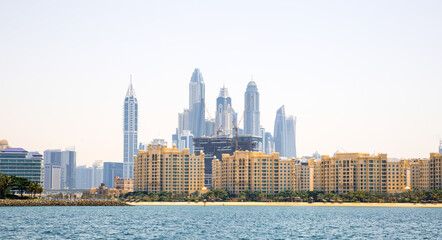 Dubai Marina skyscrapers and villas on the Palm Jumeirah. Luxury properties of UAE