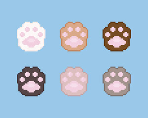 Wall Mural - Pixel paws illustration icon set. Vector pixel art paws icons. 8 bit or 16 bit retro game style animal paws icon collection. Pixel cute cartoon cat or dog paws isolated icons on blue background.
