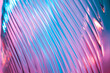Leinwandbild Motiv Abstract glass background. Texture of wavy glass illuminated with multi-colored light. Pink and blue stains. glass flares. Close up.