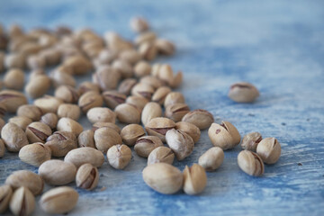 Close-up of Salted and dried Pistachios on the Blurred painted stone table as background. Concept of healthy nutrition. Selective focus. Copy space.