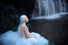 Beautiful Portrait Of A Mysterious Ethereal Elf Princess Sitting Near Waterfall