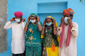 Group of Indian people in national costumes wearing face masks during the COVID-19 pandemic