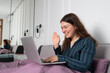 © Polina - Young attractive woman in pyjamas have a online conversation in laptop