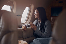 Happy Smiling Beautiful Business Woman In Private Jet
