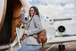 Happy caucasian beautiful dark hair businesswoman is boarding a private jet
