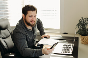 Wall Mural - office worker using smatrphone and laptop working.