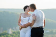 © Galka3250 - Newlyweds hug and kiss on the background of the forest. A man hugs and kisses a woman