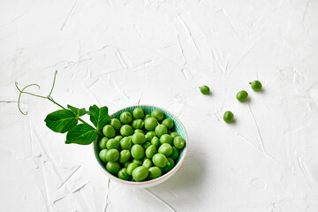 Wall Mural - Minimal food creative concept. Top view of fresh green peas in a bowl on white background.