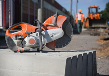 Close-up Of Concrete Curbs With A Circular Saw On A Construction Site, Road Repairs.