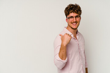 Wall Mural - Young caucasian man isolated on white background points with thumb finger away, laughing and carefree.