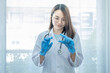 © Lucky7Trader - Asian woman doctor standing and holding vaccine bottle and syringe. Concept of health protection against epidemic disease