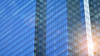 Modern office building detail, glass surface on a clear sky background. Transparent glass wall of office building.  