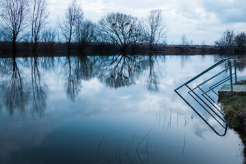 Sticker - The blue hour after sunset over the picturesque river in Lutsk, Ukraine, tranquil zen moment