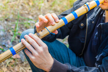 Man Playing Bamboo Flute Musical Instrument Pimak. Hands And Flute Of A Man Playing The Flute.
