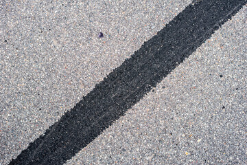 old asphalt on the road. road patch. city environment. top view close up.