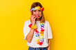 © Asier - Young caucasian woman celebrating a hawaiian party isolated on yellow background biting fingernails, nervous and very anxious.