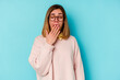 © Asier - Young student caucasian woman isolated on blue background yawning showing a tired gesture covering mouth with hand.