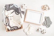 Gender Neutral Baby Garment And Accessories And Empty Frame Mockup. Organic Cotton Clothes
