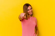 © Asier - Young caucasian skinny woman isolated on yellow background cheerful smiles pointing to front.