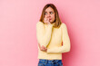 © Asier - Young caucasian woman isolated on pink background biting fingernails, nervous and very anxious.